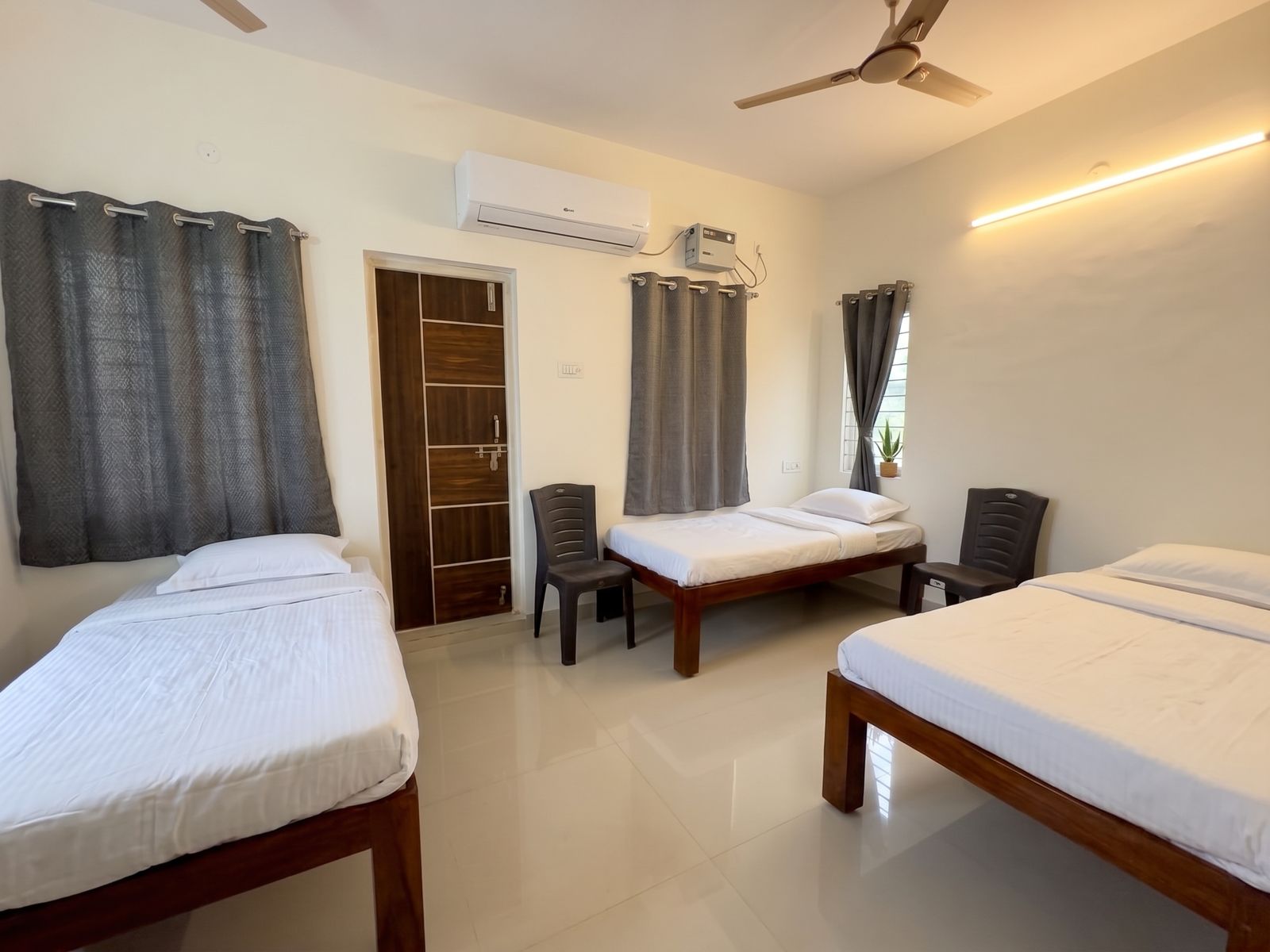 Joe Castle bedroom with three beds and AC